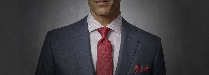 Cover image of man dressed in suite and red tie 