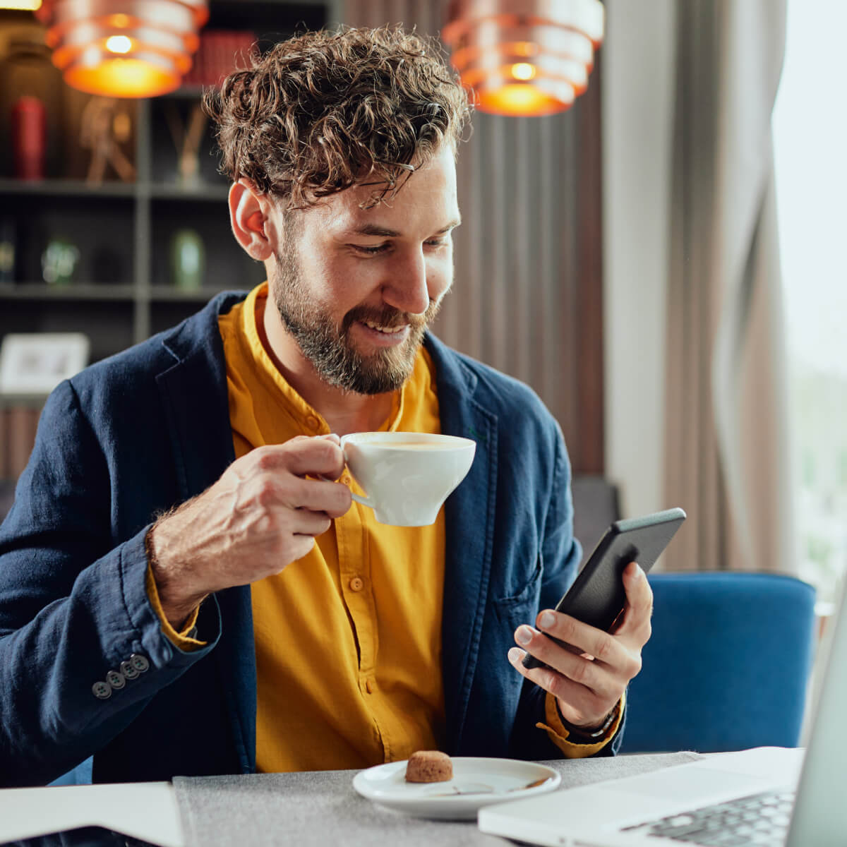 Man Enjoying Coffee While Using Smartphone