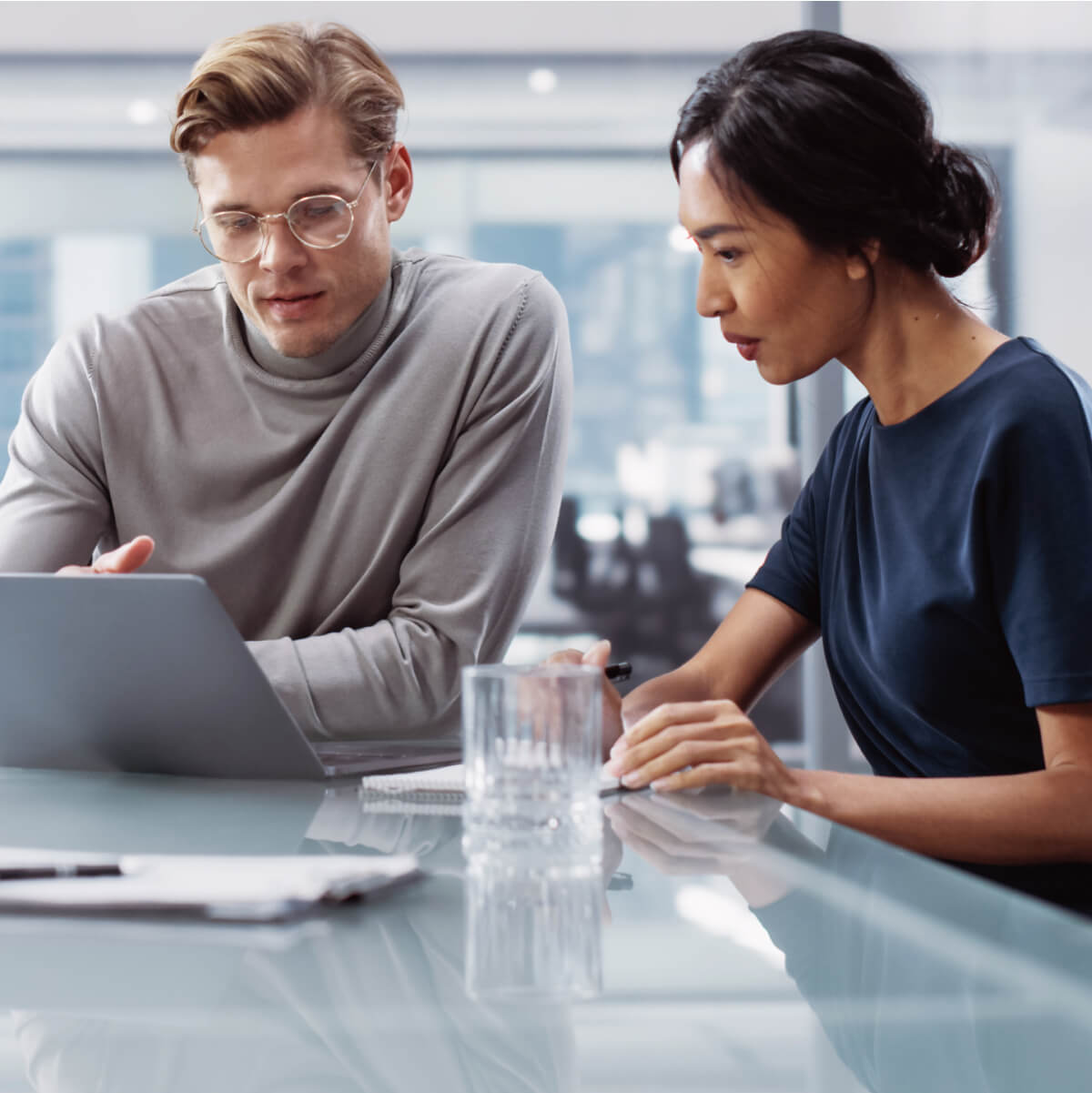 Two Professionals Collaborating Over Laptop