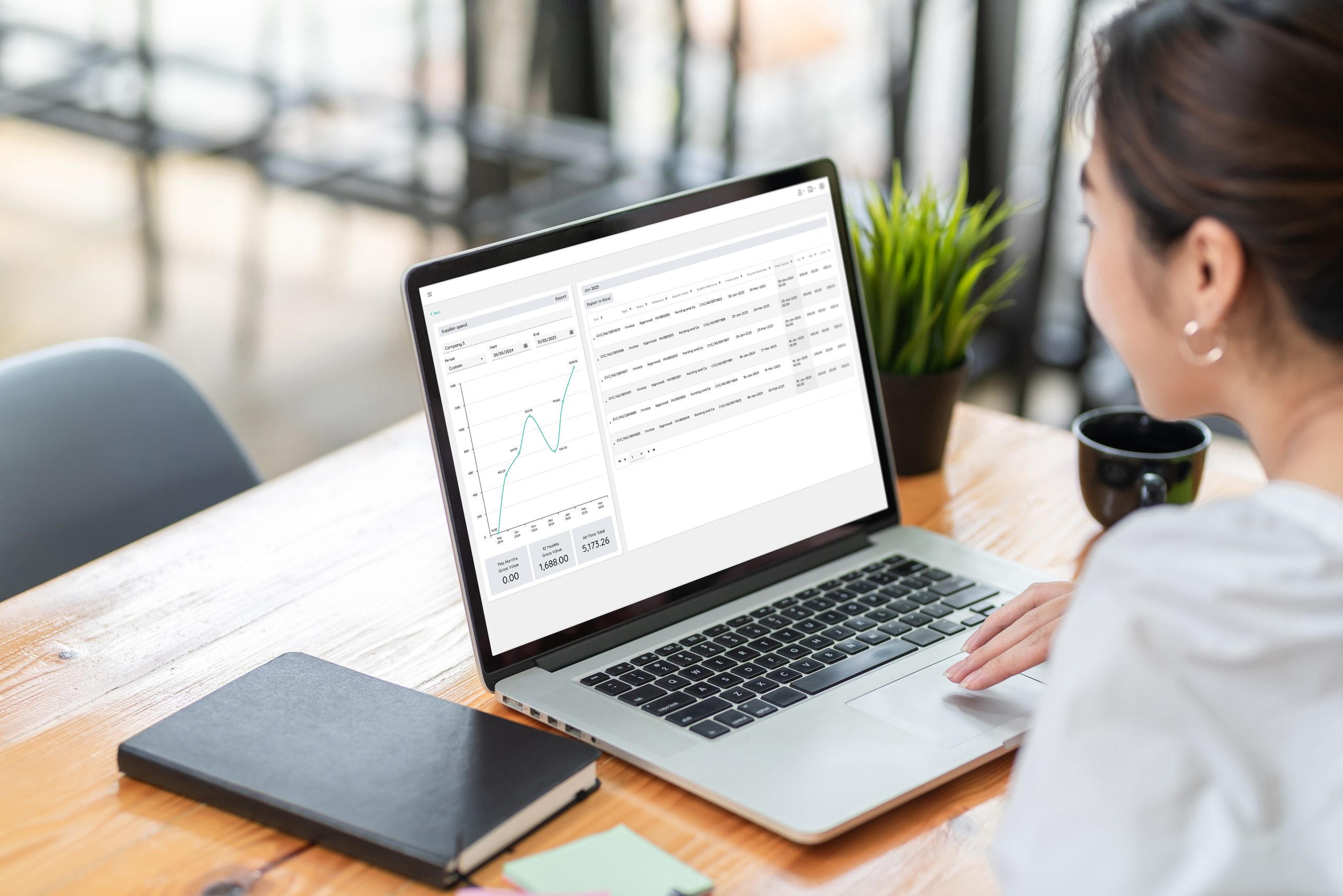 Side view of a businesswoman working on a laptop with Webexpenses system on screen