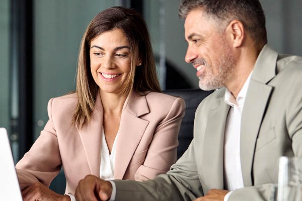 Business Meeting Collaboration – Professionals Discussing Expenses on Laptop